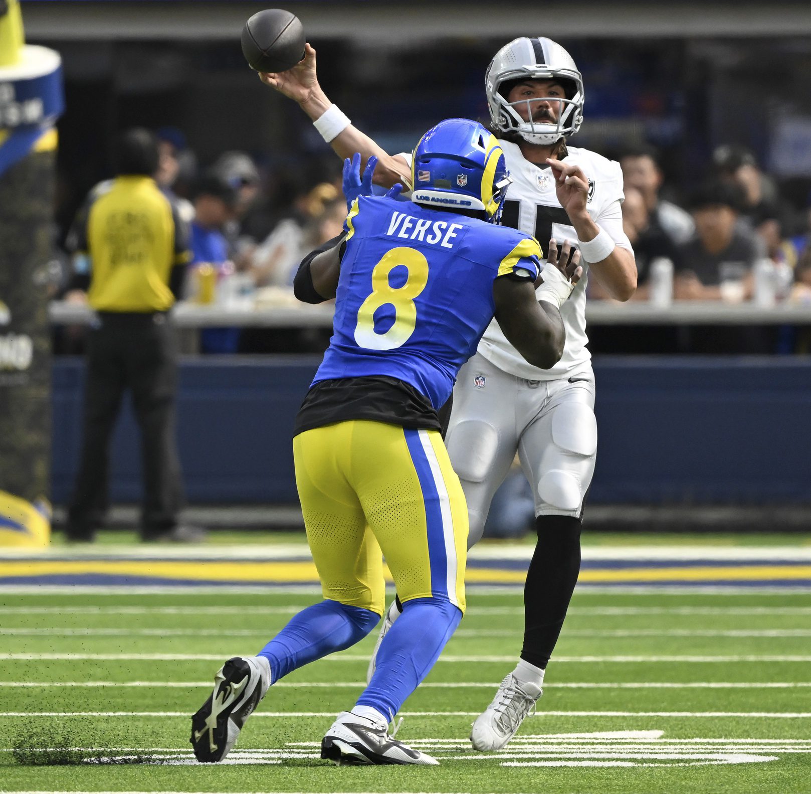 Oct 20, 2024; Inglewood, California, USA; Las Vegas Raiders quarterback Gardner Minshew (15) throws a pass over Los Angeles Rams linebacker Jared Verse (8) at SoFi Stadium. Mandatory Credit: Robert Hanashiro-Imagn Images