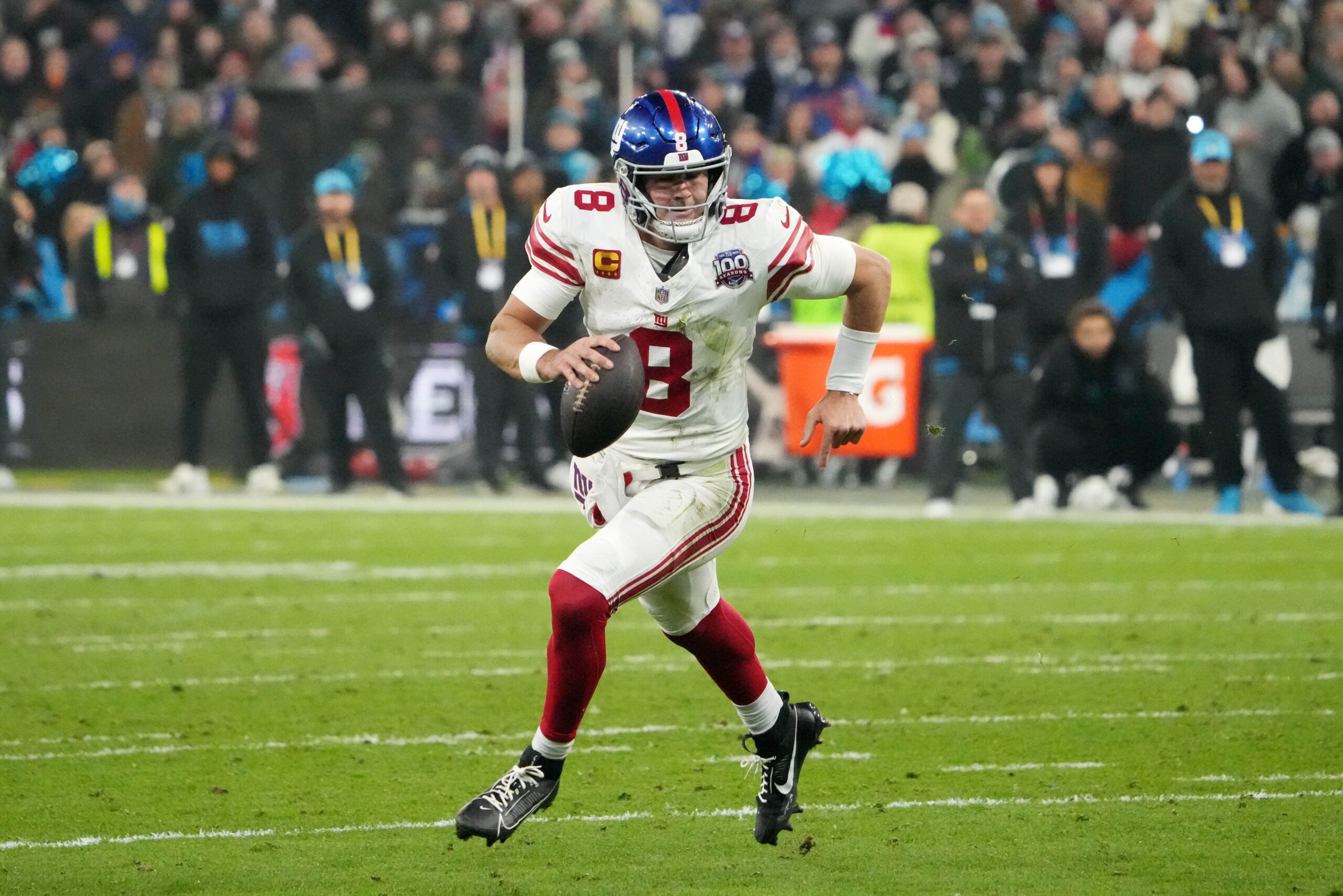 Nov 10, 2024; Munich, Germany; New York Giants quarterback Daniel Jones (8) carries the ball against the New York Giants in the second half during the 2024 NFL Munich Game at Allianz Arena. Mandatory Credit: Kirby Lee-Imagn Images Vikings