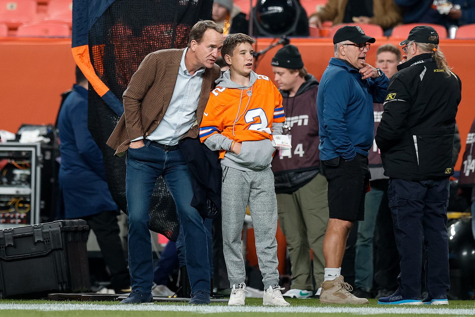 a man and boy standing on a field