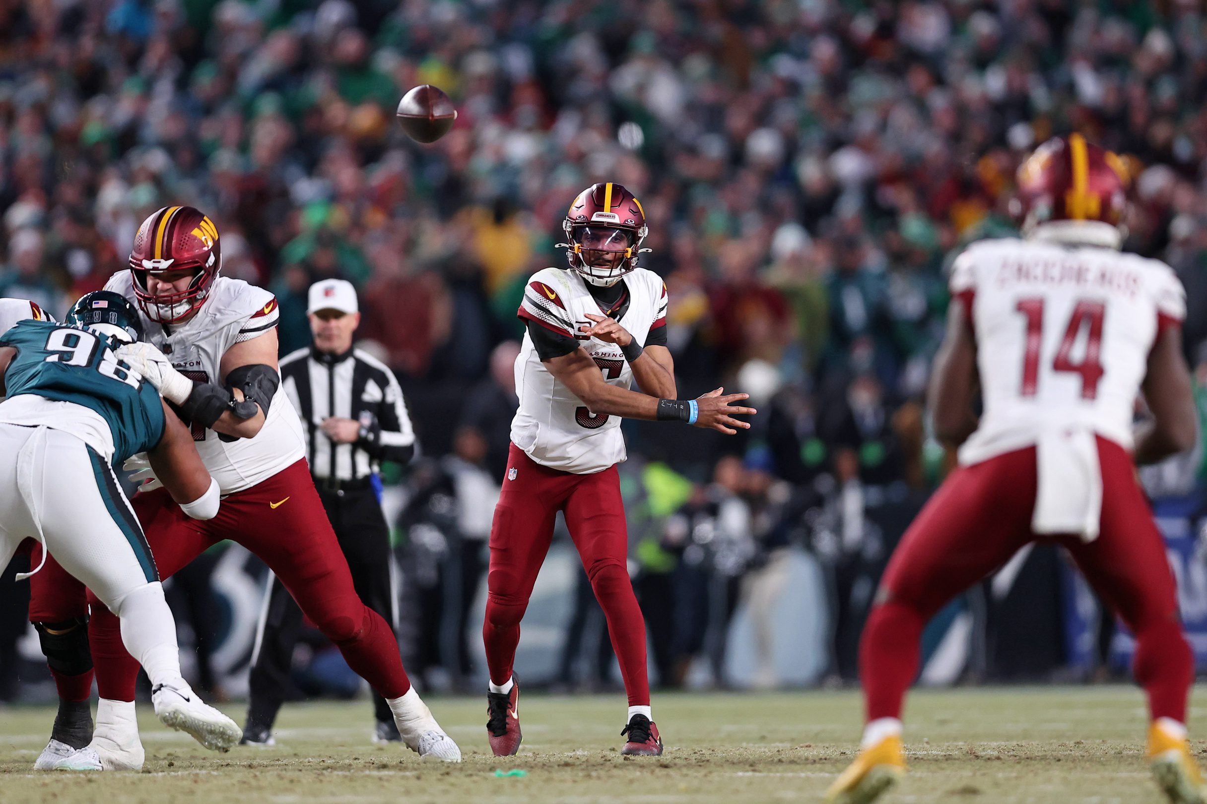 Jan 26, 2025; Philadelphia, PA, USA; Washington Commanders quarterback Jayden Daniels (5) passes the ball against the Philadelphia Eagles during the second half in the NFC Championship game at Lincoln Financial Field. Mandatory Credit: Bill Streicher-Imagn Images