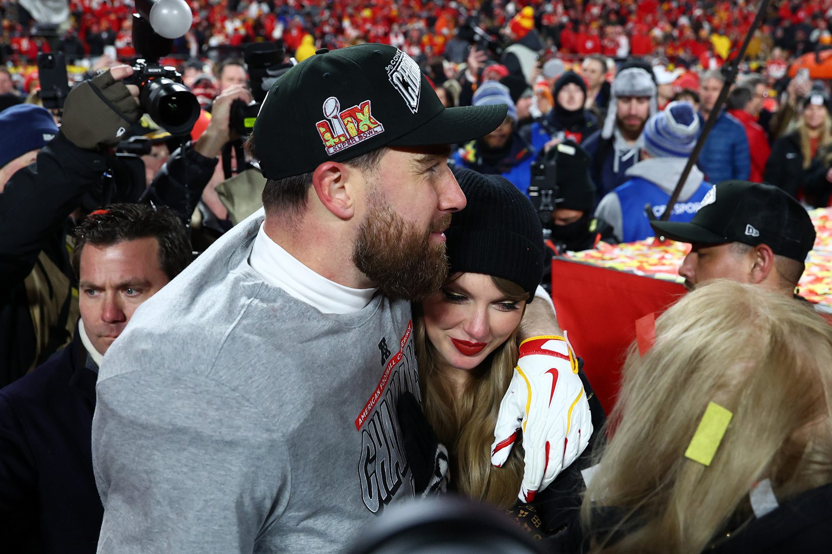 Jan 26, 2025; Kansas City, MO, USA; Recording artist Taylor Swift and Kansas City Chiefs tight end Travis Kelce (87) react after the AFC Championship game against the Buffalo Bills at GEHA Field at Arrowhead Stadium. Mandatory Credit: Mark J. Rebilas-Imagn Images