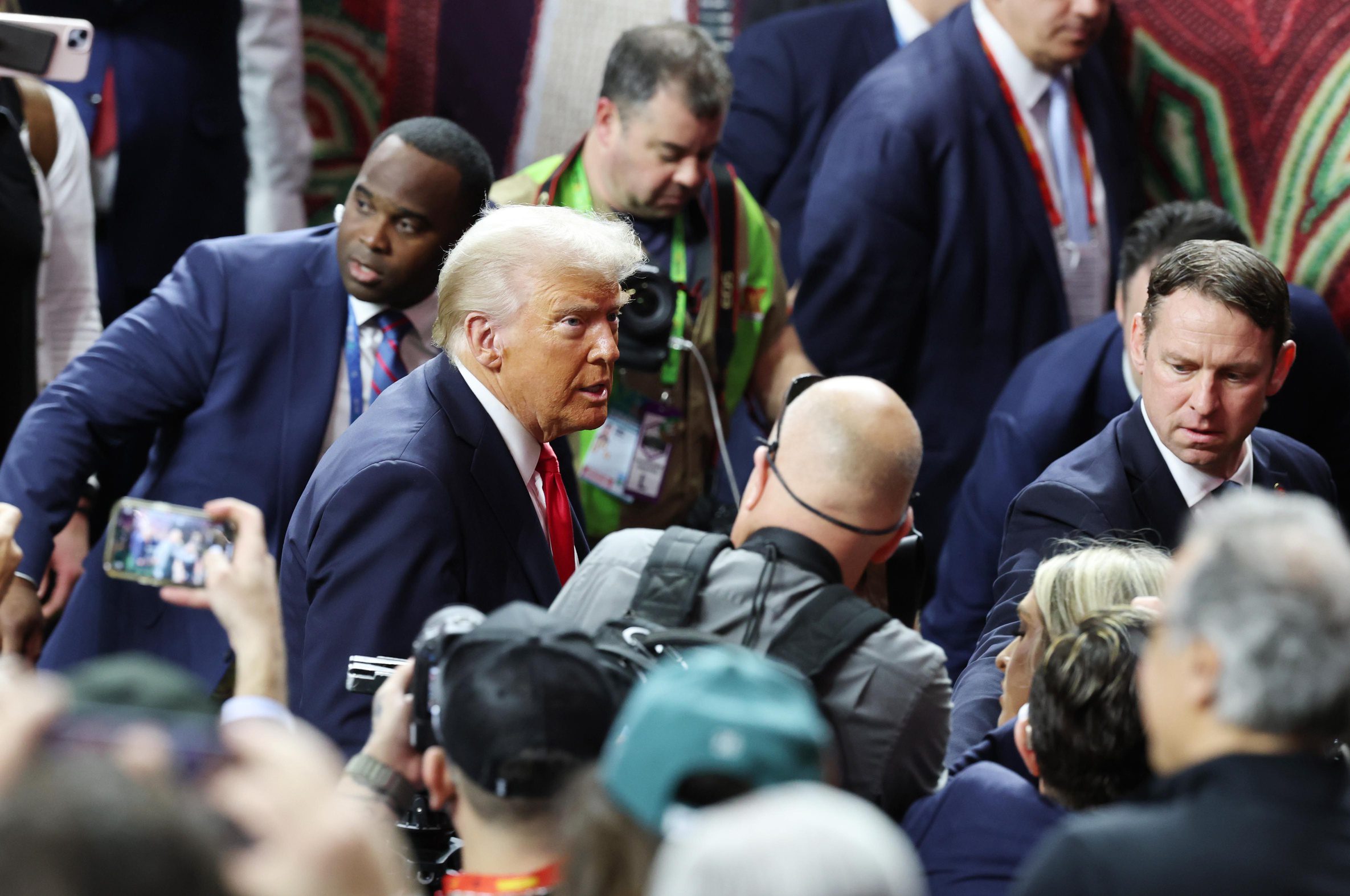 Feb 9, 2025; New Orleans, LA, USA; President Donald Trump participates in a meet and greet with the honorary coin toss participants including family members of the victims from the terrorist attack, members of the New Orleans Police Department, and emergency personnel before Super Bowl LIX between the Philadelphia Eagles and the Kansas City Chiefs at Ceasars Superdome. Mandatory Credit: Stephen Lew-Imagn Images