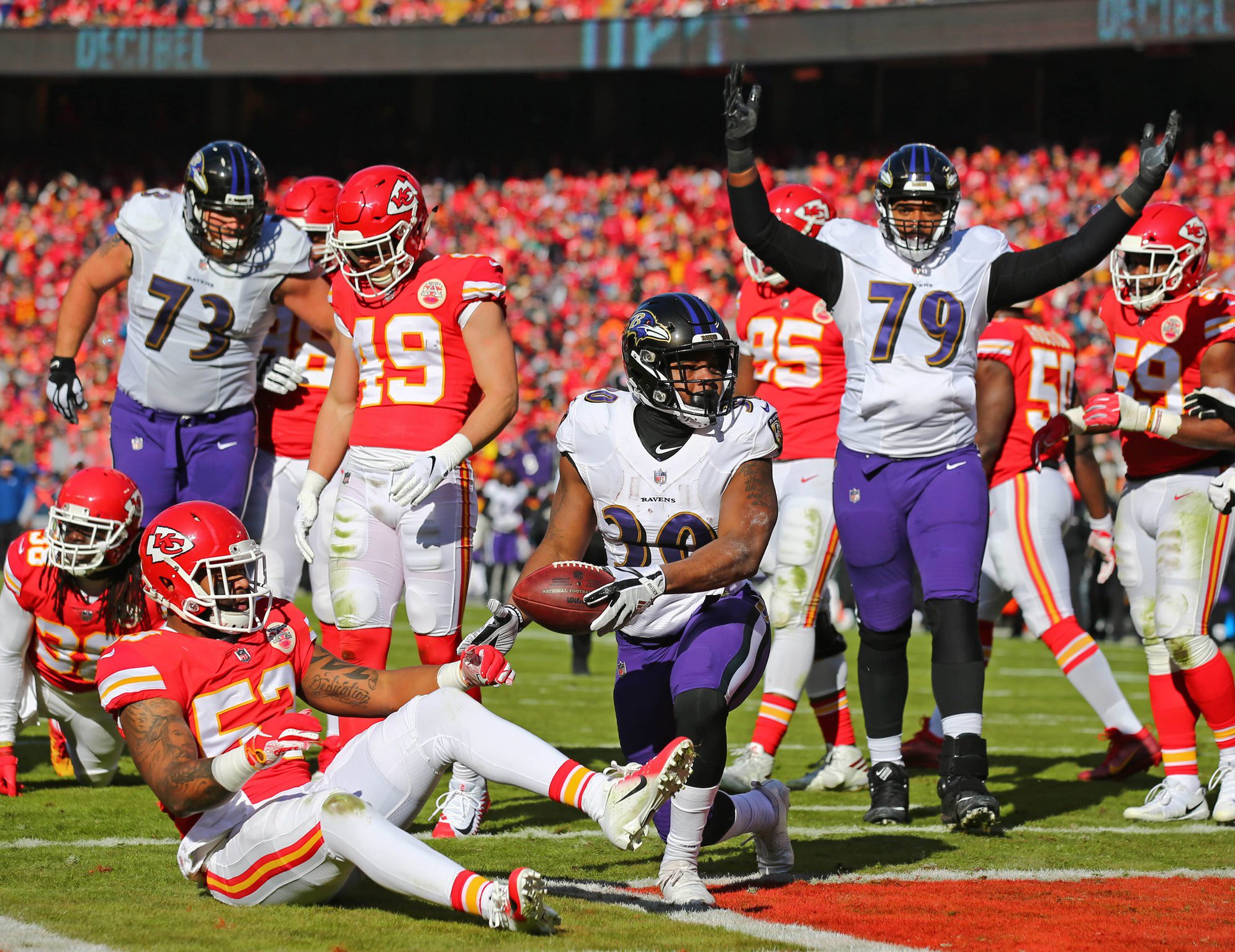 Dec 9, 2018; Kansas City, MO, USA; Baltimore Ravens running back Kenneth Dixon (30) and Baltimore Ravens offensive tackle Ronnie Stanley (79) celebrate after scoring a touchdown against the Kansas City Chiefs in the first half at Arrowhead Stadium. Mandatory Credit: Jay Biggerstaff-Imagn Images