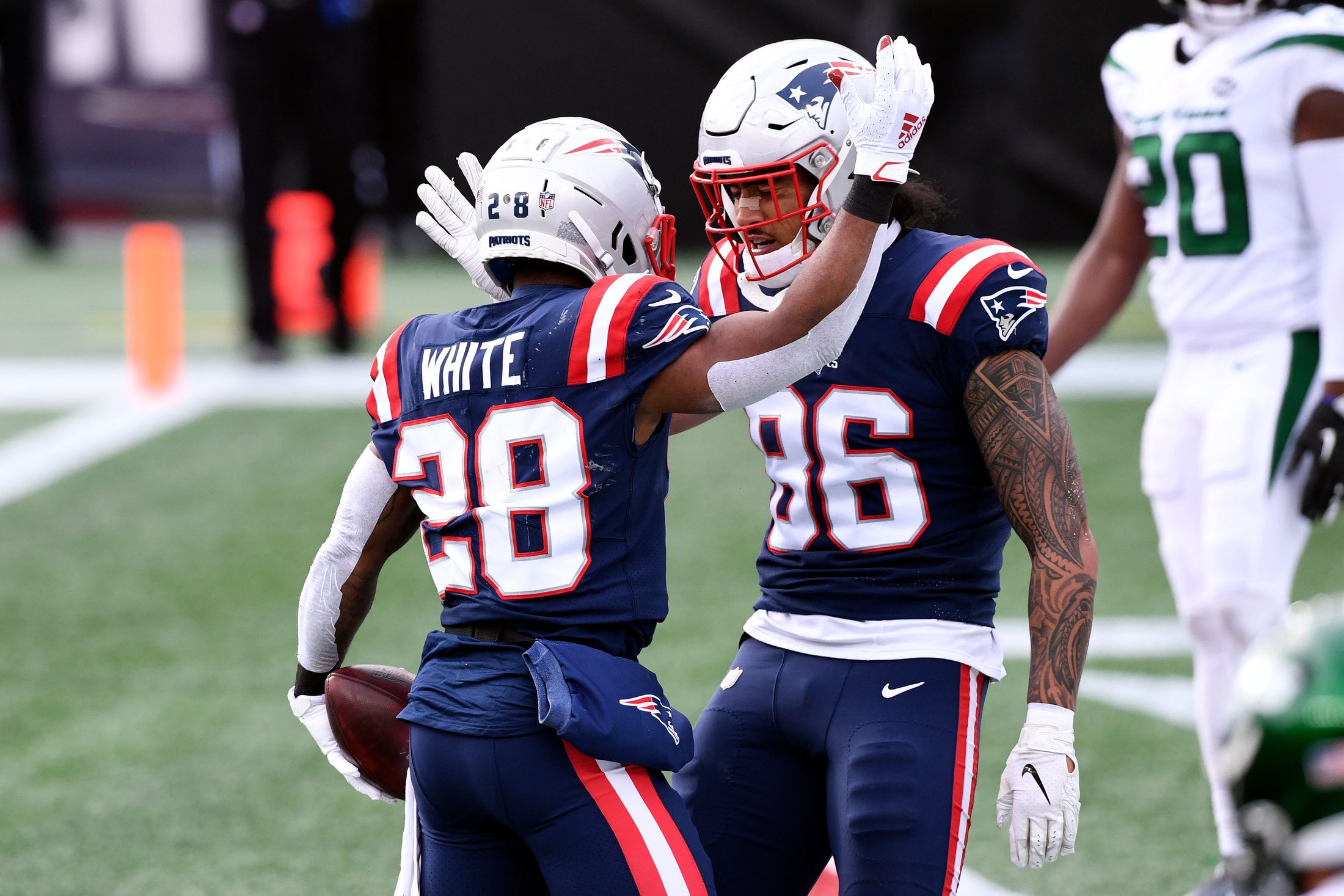 Jan 3, 2021; Foxborough, Massachusetts, USA; New England Patriots running back James White (28) celebrates with tight end Devin Asiasi (86) after scoring a touchdown against the New York Jets during the first quarter at Gillette Stadium. Mandatory Credit: Brian Fluharty-Imagn Images