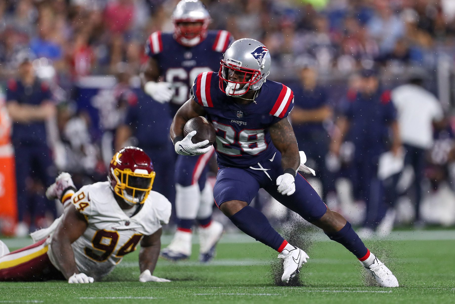 Aug 12, 2021; Foxborough, Massachusetts, USA; New England Patriots running back James White (28) runs the ball against the Washington Football Team during the first half at Gillette Stadium. Mandatory Credit: Paul Rutherford-Imagn Images