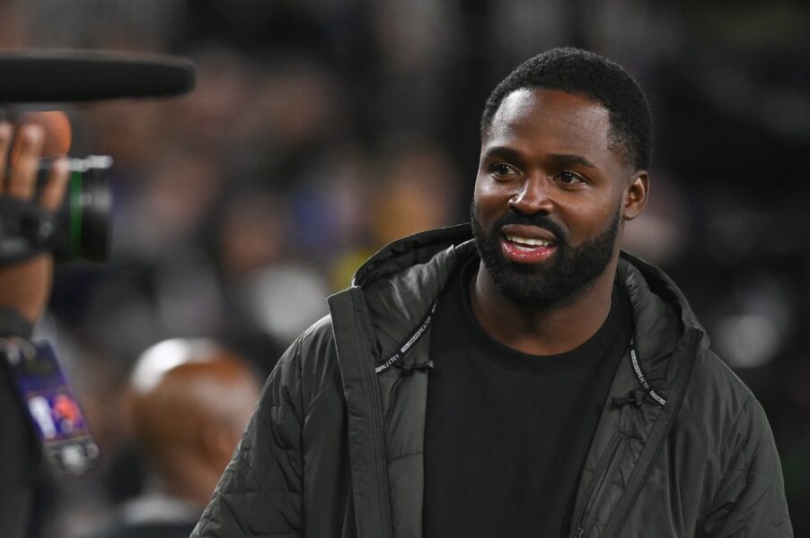 Former professional football player Torrey Smith stands on the sidelines during the game between the Baltimore Ravens and the Cincinnati Bengals