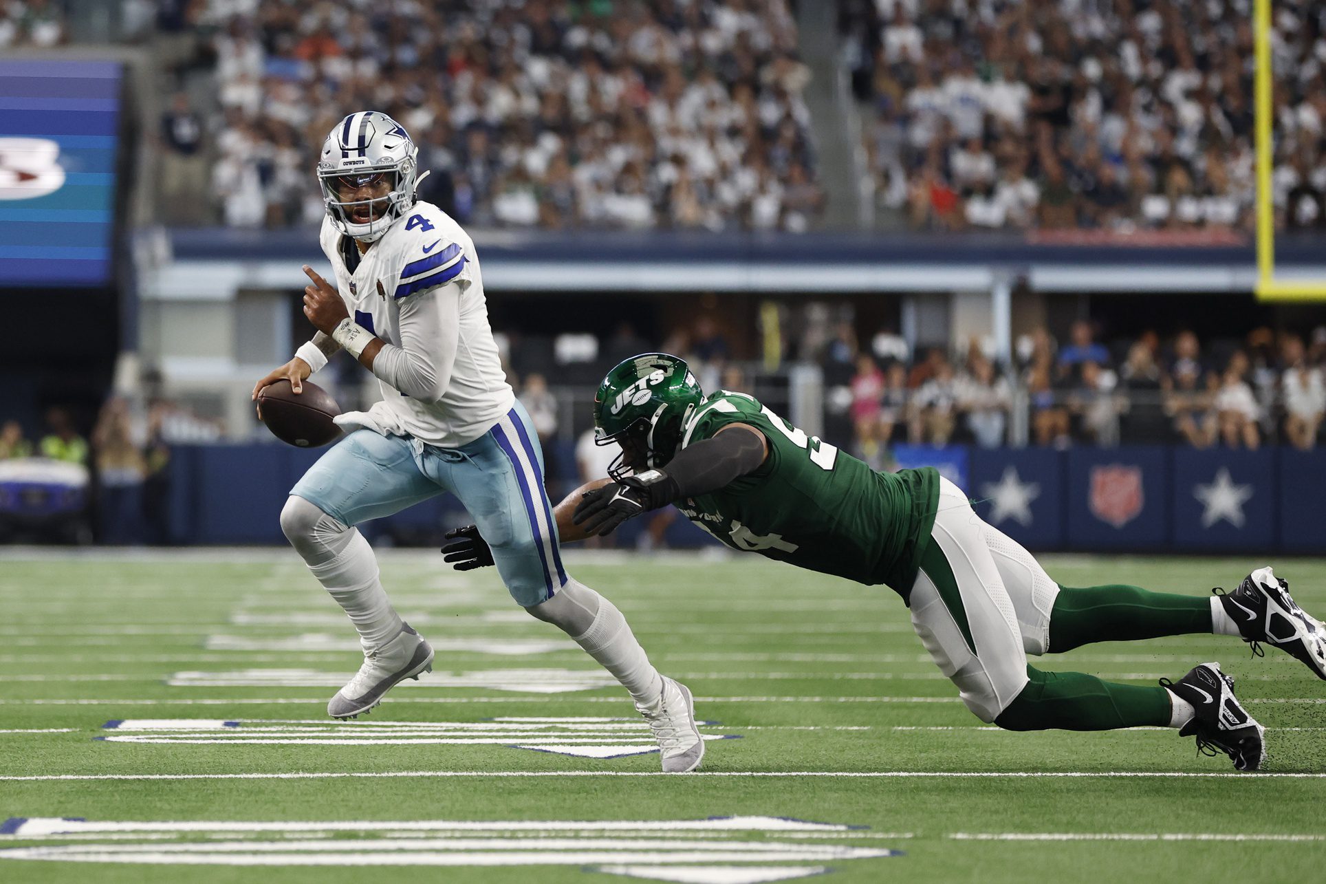 Sep 17, 2023; Arlington, Texas, USA; Dallas Cowboys quarterback Dak Prescott (4) is tackled by New York Jets defensive end Solomon Thomas (94) in the second quarter at AT&T Stadium. Mandatory Credit: Tim Heitman-Imagn Images