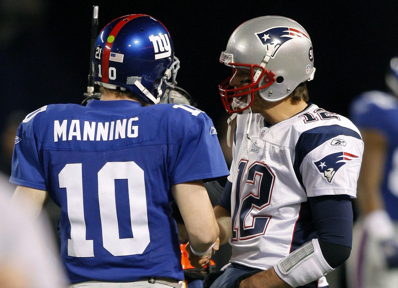 Dec 29, 2007; East Rutherford, NJ, USA; New York Giants quarterback Eli Manning (10) and New England Patriots quarterback Tom Brady (12) exchange greetings prior to game at Giants Stadium. Mandatory Credit: Jim O'Connor-Imagn Images