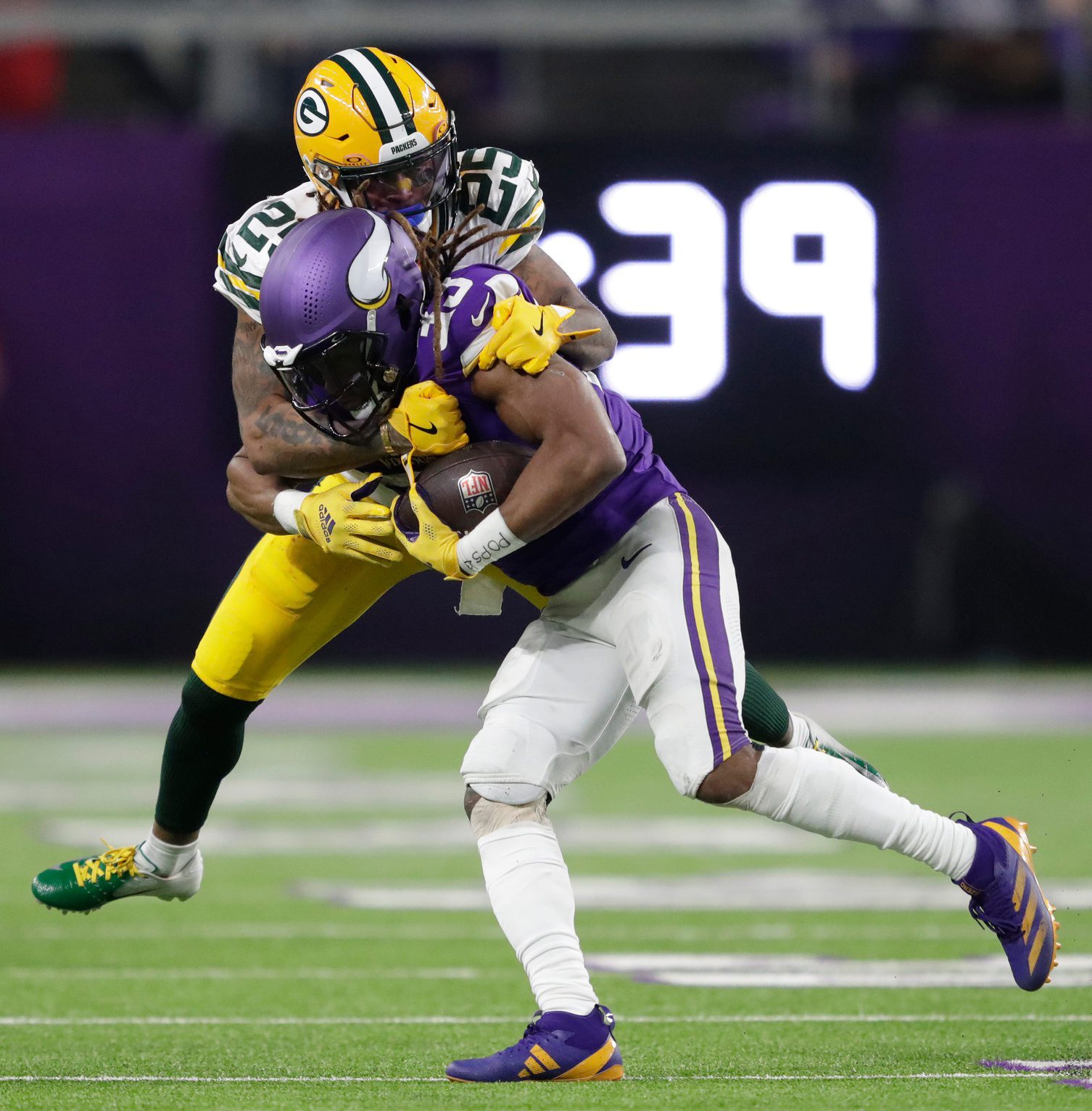 Minnesota Vikings running back Aaron Jones (33) gains a first down on a reception against Green Bay Packers cornerback Keisean Nixon (25) in the third quarter of their football game Sunday, December 29, 2024, at U.S. Bank Stadium in Minneapolis, Minnesota. © Dan Powers/USA TODAY NETWORK-Wisconsin / USA TODAY NETWORK via Imagn Images