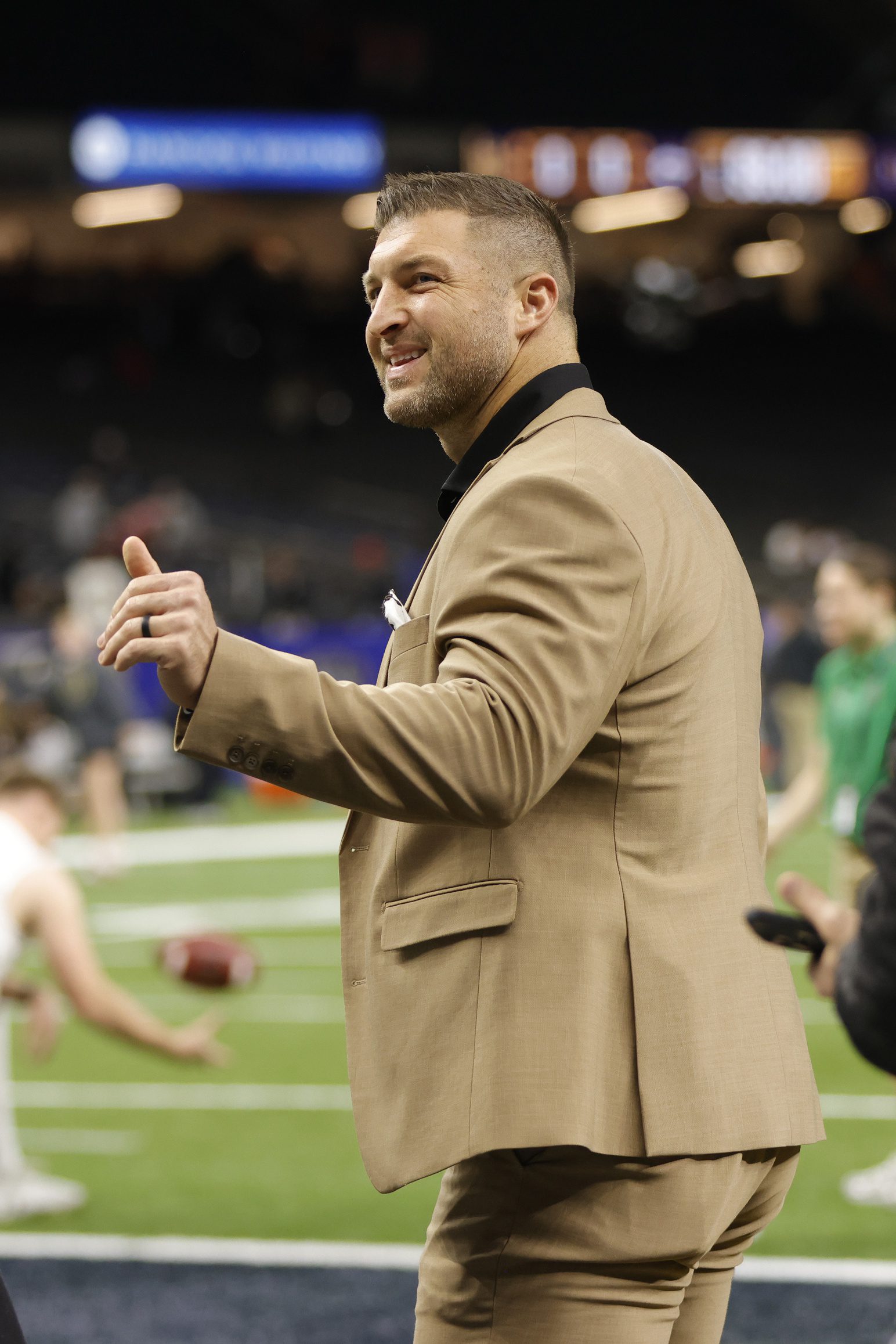 Jan 2, 2025; New Orleans, LA, USA; Tim Tebow waves to fans in the stands prior to the game between the Notre Dame Fighting Irish and the Georgia Bulldogs at Caesars Superdome. Mandatory Credit: Amber Searls-Imagn Images