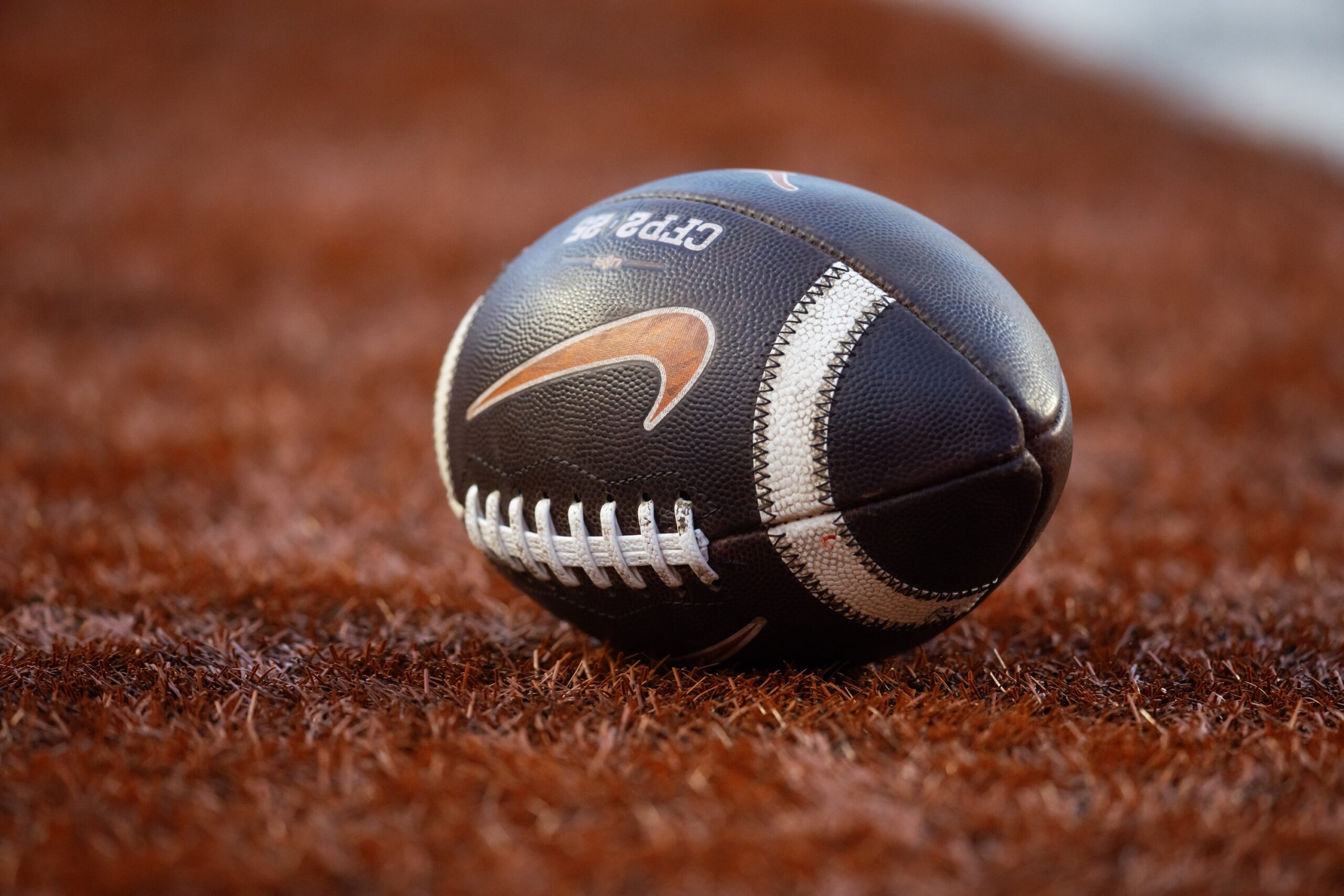 BREAKING: Head Coach Tragically Dies In Car Accident; Details Emerging 1 Dec 21, 2024; Austin, Texas, USA; Detailed view of a Nike logo on an official NCAA football during the Clemson Tigers game against the Texas Longhorns in the CFP National playoff first round at Darrell K Royal-Texas Memorial Stadium. Mandatory Credit: Mark J. Rebilas-Imagn ImagesHead coach