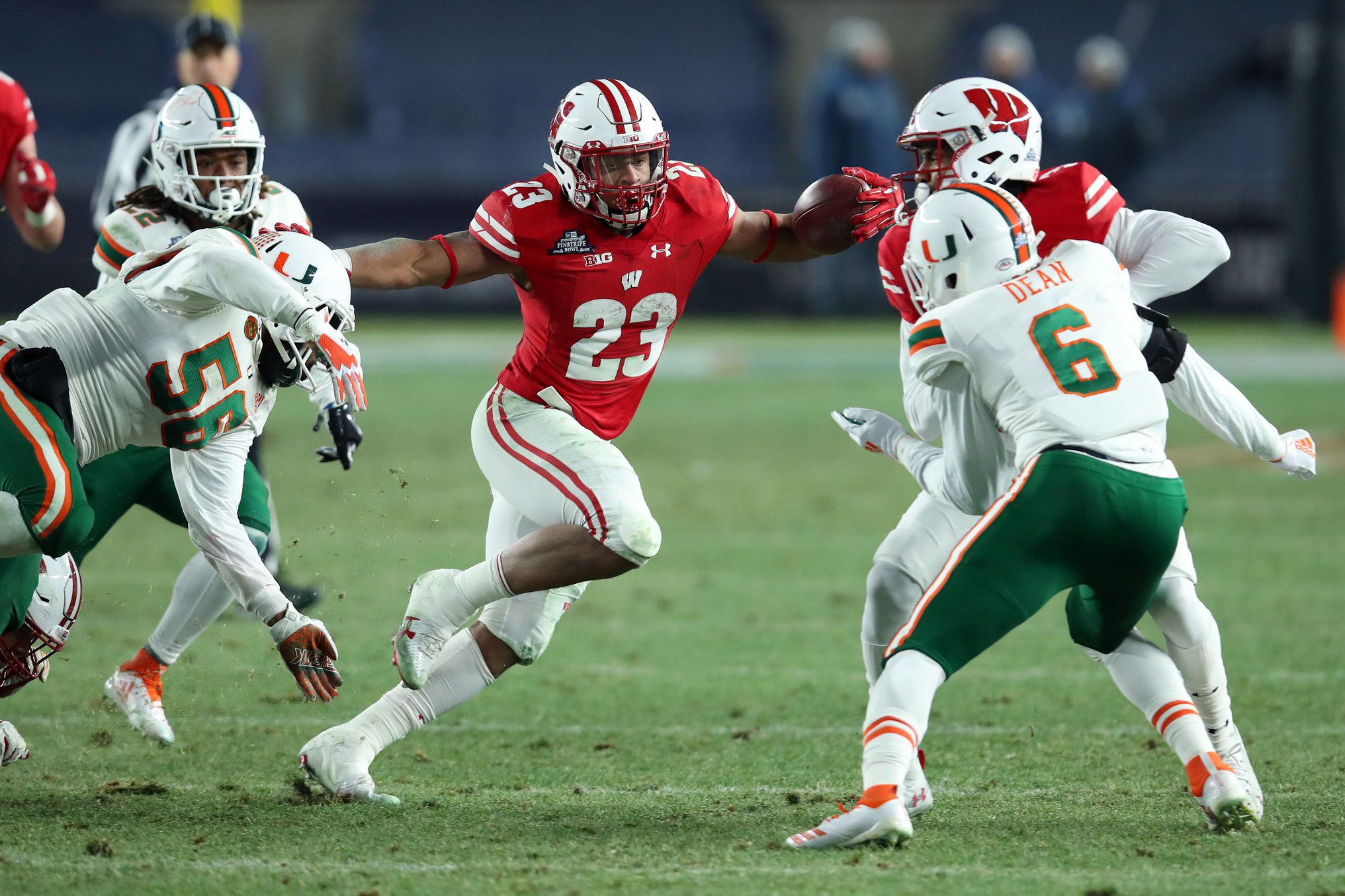 Miami Suddenly Facing "First-Of-Its-Kind" Lawsuit From Big Ten School (Breaking) 3 Dec 27, 2018; Bronx, NY, USA; Wisconsin Badgers running back Jonathan Taylor (23) runs with the ball past Miami Hurricanes linebacker Michael Pinckney (56) during the second quarter in the 2018 Pinstripe Bowl at Yankee Stadium. Mandatory Credit: Rich Barnes-Imagn Images