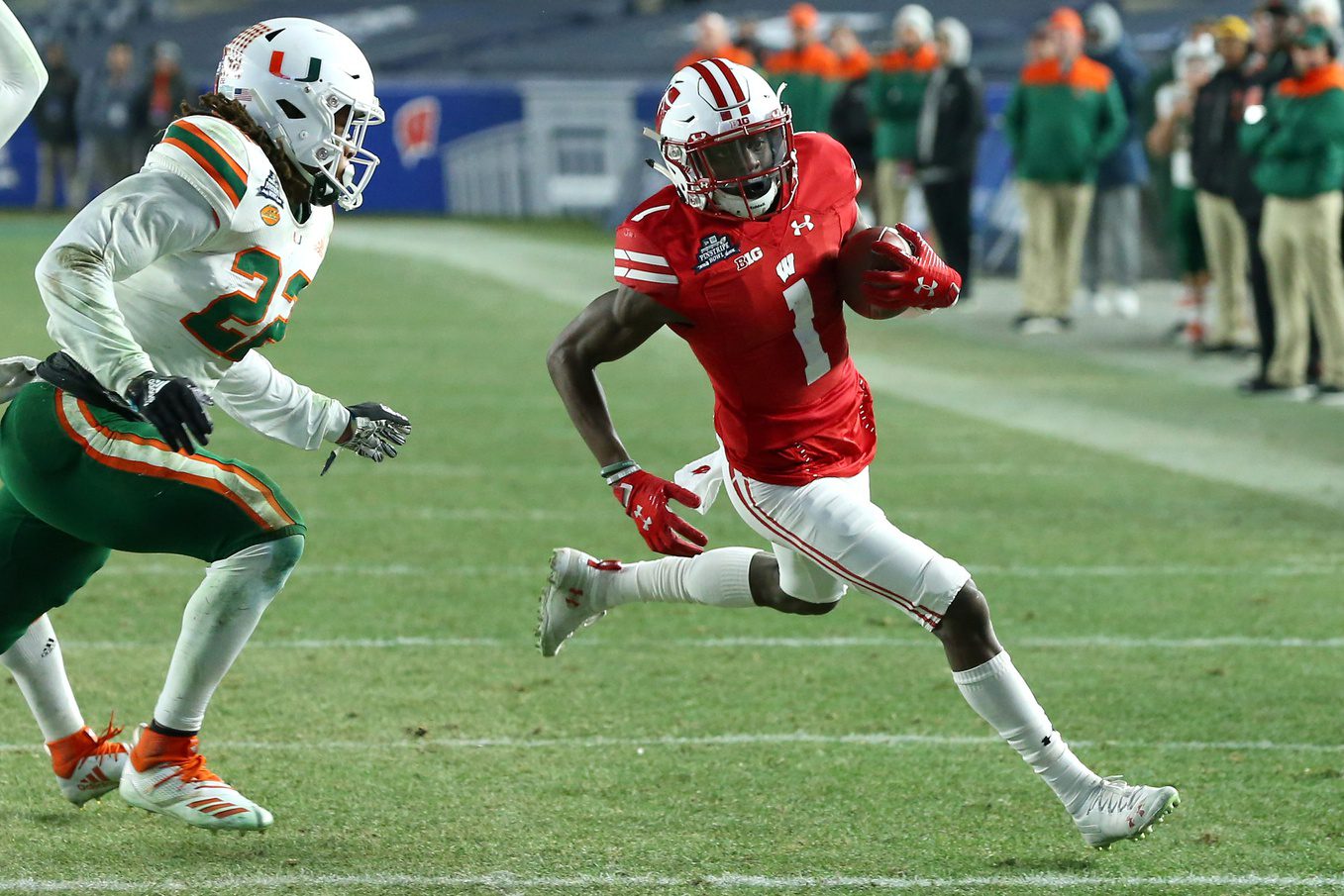 Miami Suddenly Facing "First-Of-Its-Kind" Lawsuit From Big Ten School (Breaking) 2 Dec 27, 2018; Bronx, NY, USA; Wisconsin Badgers wide receiver Aron Cruickshank (1) runs with the ball past Miami Hurricanes defensive back Sheldrick Redwine (22) during the fourth quarter in the 2018 Pinstripe Bowl at Yankee Stadium. Mandatory Credit: Rich Barnes-Imagn Images