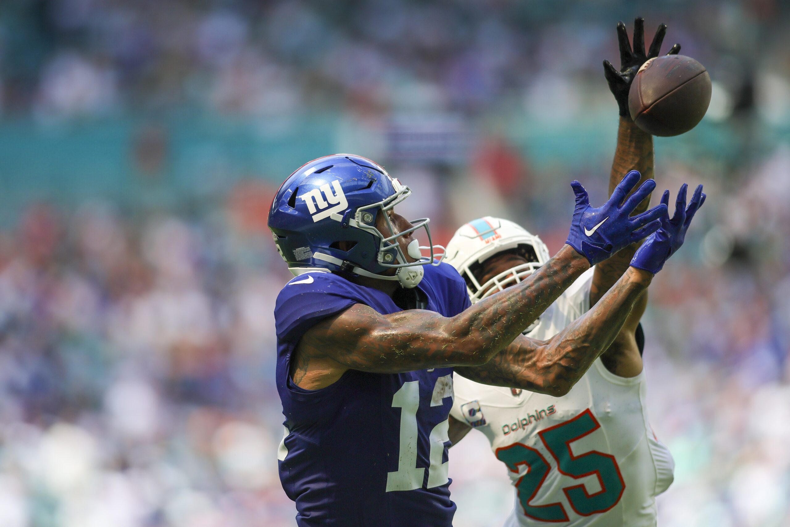 Oct 8, 2023; Miami Gardens, Florida, USA; New York Giants tight end Darren Waller (12) reaches for the football but cannot make a catch against Miami Dolphins cornerback Xavien Howard (25) during the second quarter at Hard Rock Stadium. Mandatory Credit: Sam Navarro-USA TODAY Sports NFL