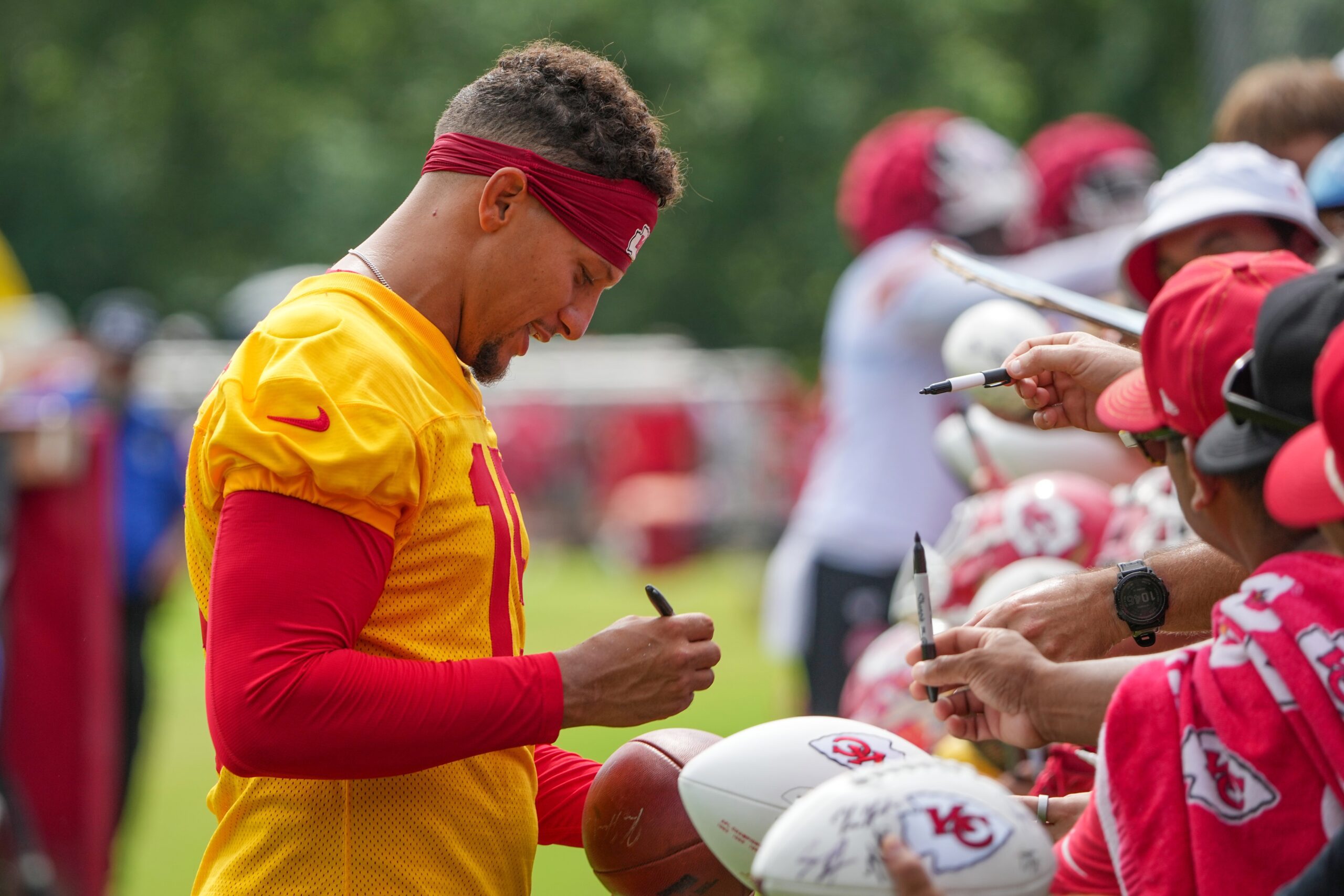 Jul 22, 2025; St. Joseph, MO, USA; Kansas City Chiefs quarterback Patrick Mahomes (15) signs autographs for fans after training camp at Missouri Western State University. Mandatory Credit: Denny Medley-Imagn Images