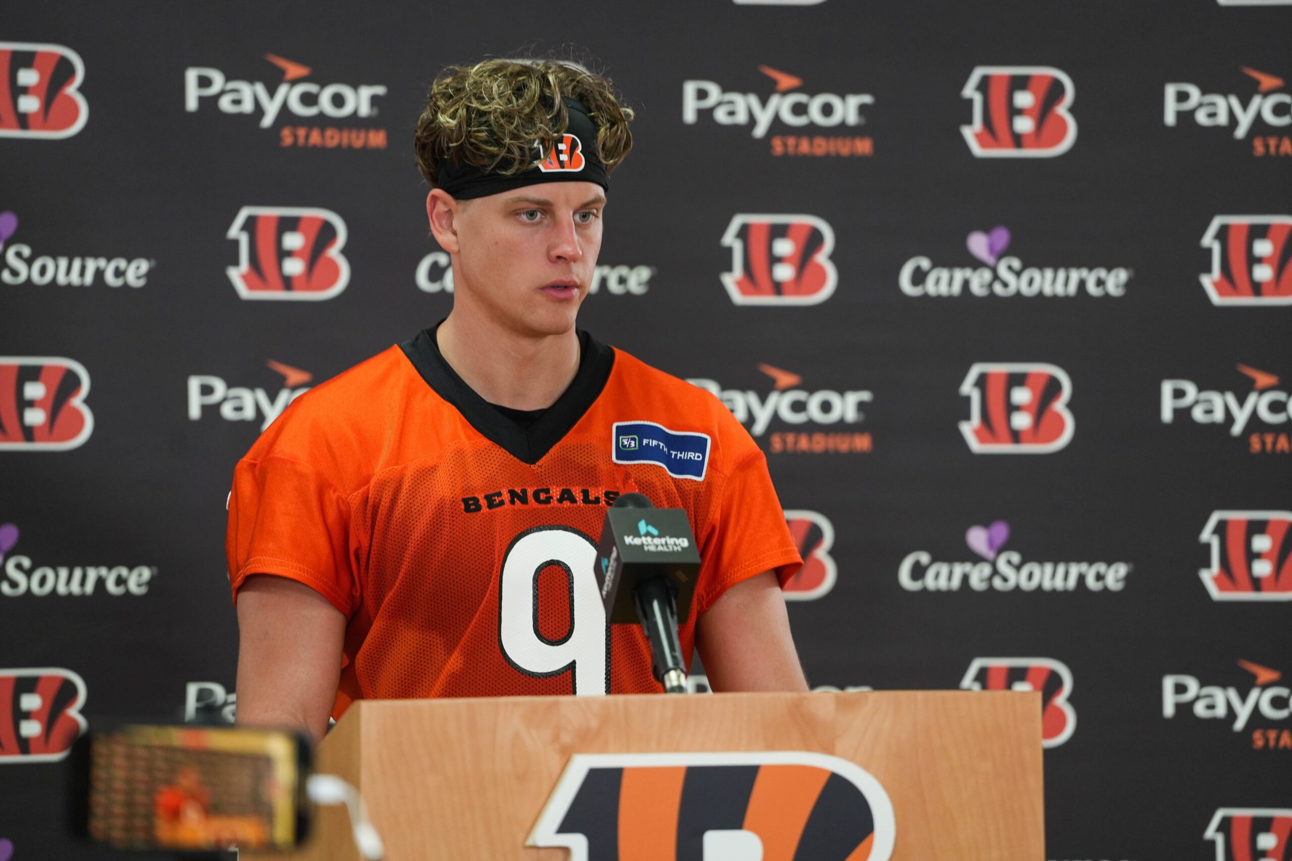 "I Was Pretty Uncomfortable With My Own Skin": Joe Burrow Spills Mom's Secret Role In His Style Growing Up That Cured His Awkward Phase 2 The Cincinnati Bengals Joe Burrow (9) speaks at a press conference after their practice on Tuesday May 20, 2025.
