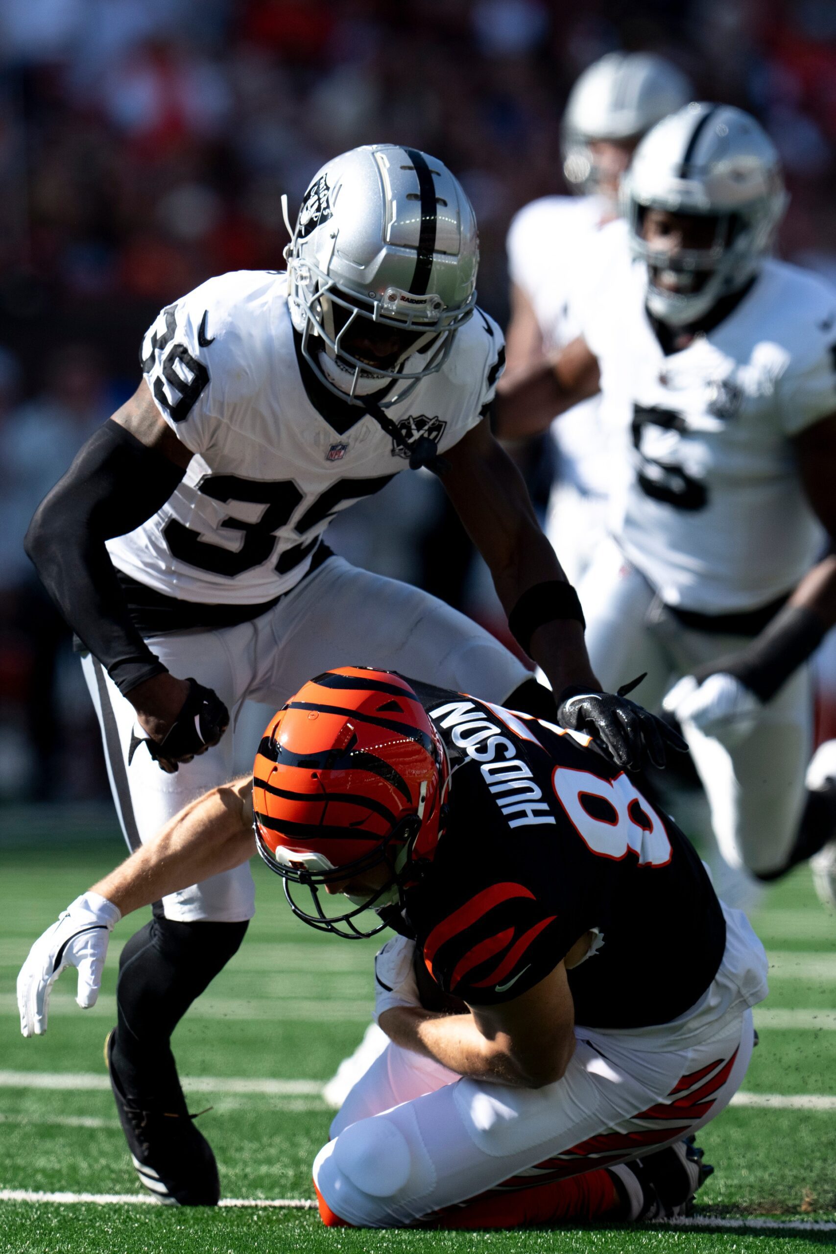 Las Vegas Raiders corner back Nate Hobbs (39) tackles Cincinnati Bengals tight end Tanner Hudson (87) after he gets a first down on fourth down in the first quarter of the NFL game at Paycor Stadium in Cincinnati on Sunday, Nov. 3, 2024. © Albert Cesare/The Enquirer / USA TODAY NETWORK via Imagn Images