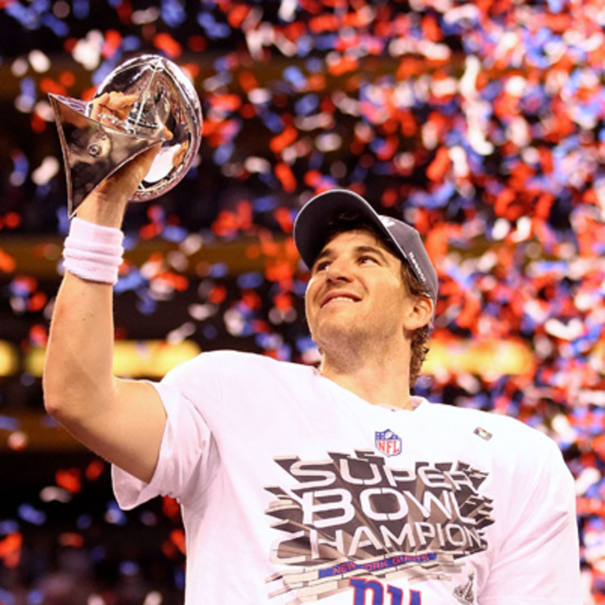 Eli Manning hoisting the Super Bowl trophy