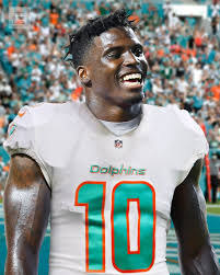 Tyreek hill smiling in Dolphins jersey at practice