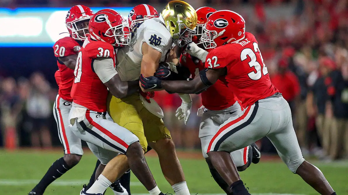 Georgia defenders tackle a Notre Dame ballcarrier
