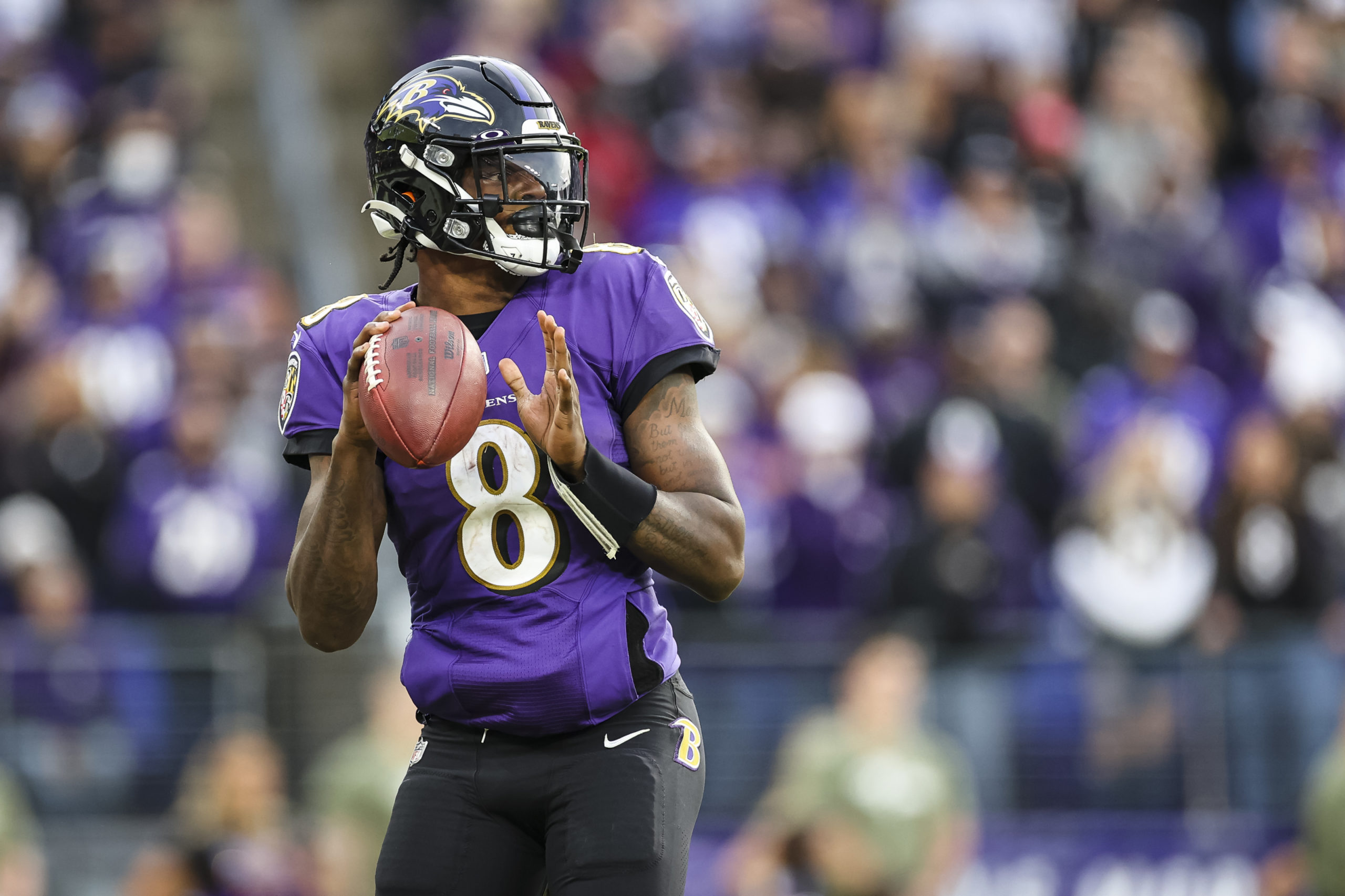 Baltimore Ravens Qb Lamar Jackson drops back to pass in 2021.