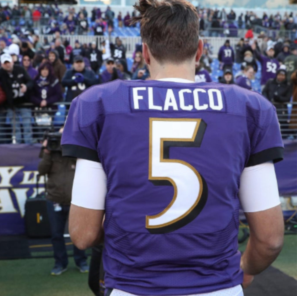 Joe Flacco leaves the field after his final NFL game as a Raven.