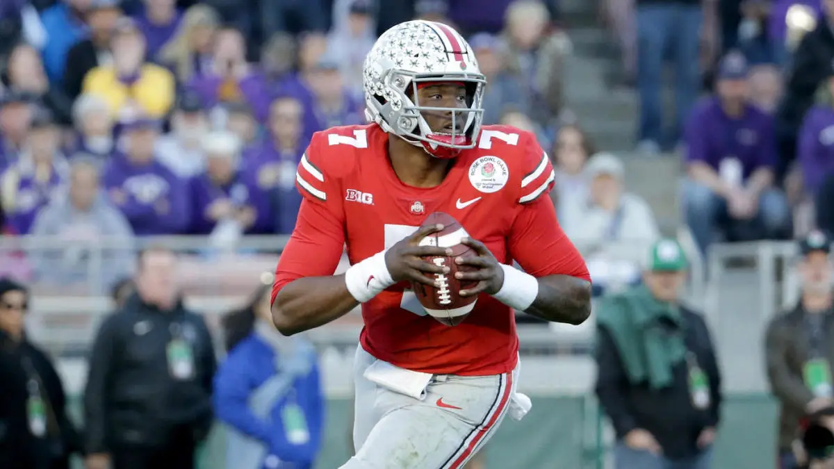 Dwanye Haskins rolls at right against Washington in the Rose Bowl.