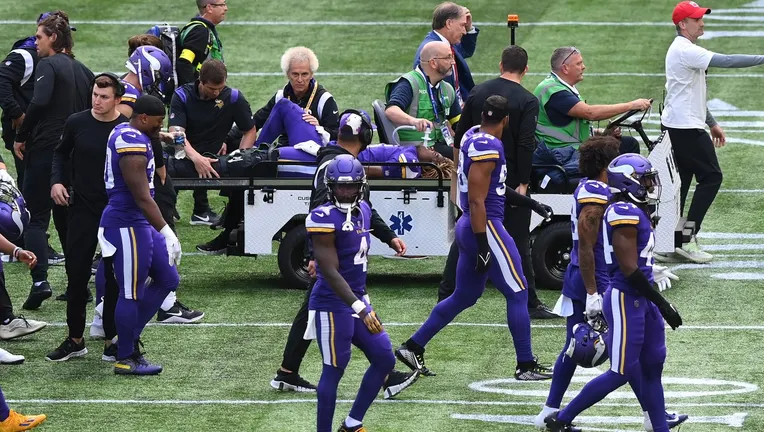 Vikings safety Lewis Cine is carted off the field after suffering a fractured leg against the Saints.