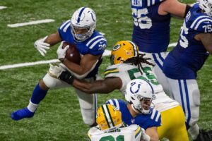 Nov 22, 2020; Indianapolis, Indiana, USA; Indianapolis Colts running back Jonathan Taylor (28) runs the ball against Green Bay Packers outside linebacker Za'Darius Smith (55) in overtime at Lucas Oil Stadium. Mandatory Credit: Trevor Ruszkowski-USA TODAY Sports