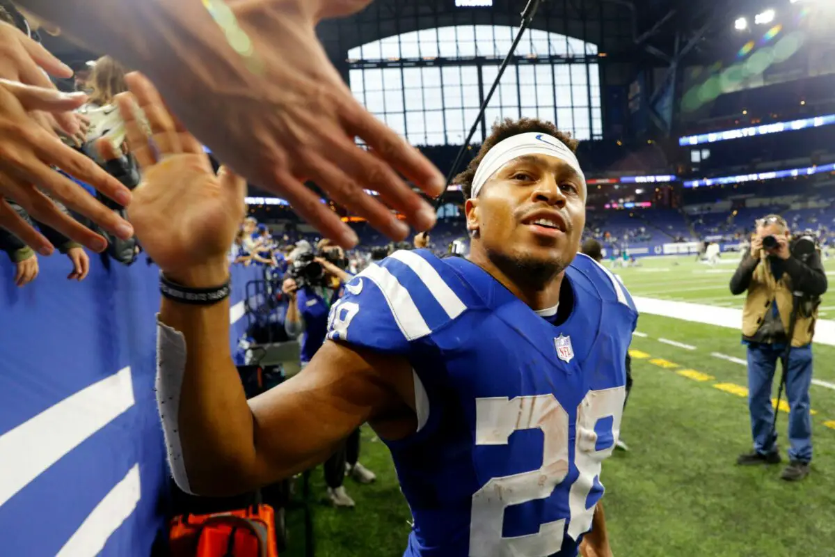 Indianapolis running back Jonathan T. (28) high fives a fan as he leaves the field Sunday, Nov. 14, 2021, after defeating the Jacksonville Jaguars 23-17 at Lucas Oil Stadium in Indianapolis.© Robert Scheer/IndyStar / USA TODAY NETWORK