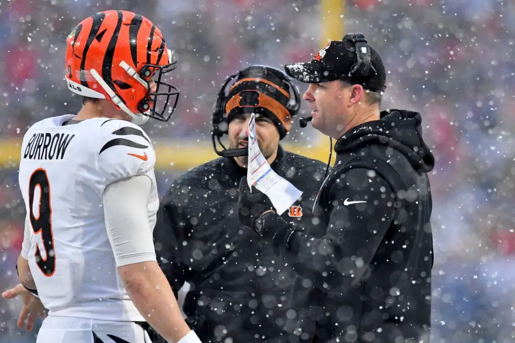 Jan 22, 2023; Orchard Park, New York, USA; Cincinnati Bengals quarterback Joe Burrow (9) talks with head coach Zac Taylor during the second quarter of an AFC divisional round game against the Buffalo Bills at Highmark Stadium. Mandatory Credit: Mark Konezny-USA TODAY Sports