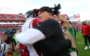Dec 29, 2019; Tampa, Florida, USA; Atlanta Falcons head coach Dan Quinn hugs linebacker Deion Jones (45) as he intercepted the ball and ran it back for a touchdown during overtime against the Tampa Bay Buccaneers at Raymond James Stadium. Mandatory Credit: Kim Klement-USA TODAY Sports
