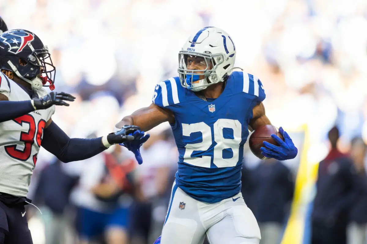 Oct 17, 2021; Indianapolis, Indiana, USA; Indianapolis Colts running back Jonathan Taylor (28) runs the ball while Houston Texans cornerback Terrance Mitchell (39) defends in the second half at Lucas Oil Stadium. Mandatory Credit: Trevor Ruszkowski-USA TODAY Sports