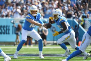 Sep 17, 2023; Nashville, Tennessee, USA; Los Angeles Chargers quarterback Justin Herbert (10) hands the ball off to running back Joshua Kelley (25) during the first half against the Tennessee Titans at Nissan Stadium. Mandatory Credit: Christopher Hanewinckel-USA TODAY Sports (Minnesota Vikings)