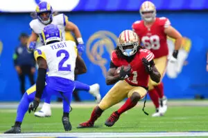 Sep 17, 2023; Inglewood, California, USA; San Francisco 49ers wide receiver Brandon Aiyuk (11) runs the ball against Los Angeles Rams safety Russ Yeast (2) during the second half at SoFi Stadium. Mandatory Credit: Gary A. Vasquez-USA TODAY Sports