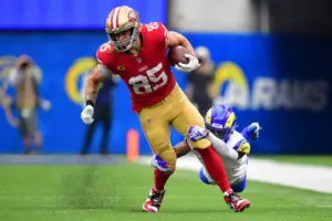 Sep 17, 2023; Inglewood, California, USA; San Francisco 49ers tight end George Kittle (85) runs the ball against Los Angeles Rams safety Jordan Fuller (4) during the second half at SoFi Stadium. Mandatory Credit: Gary A. Vasquez-USA TODAY Sports