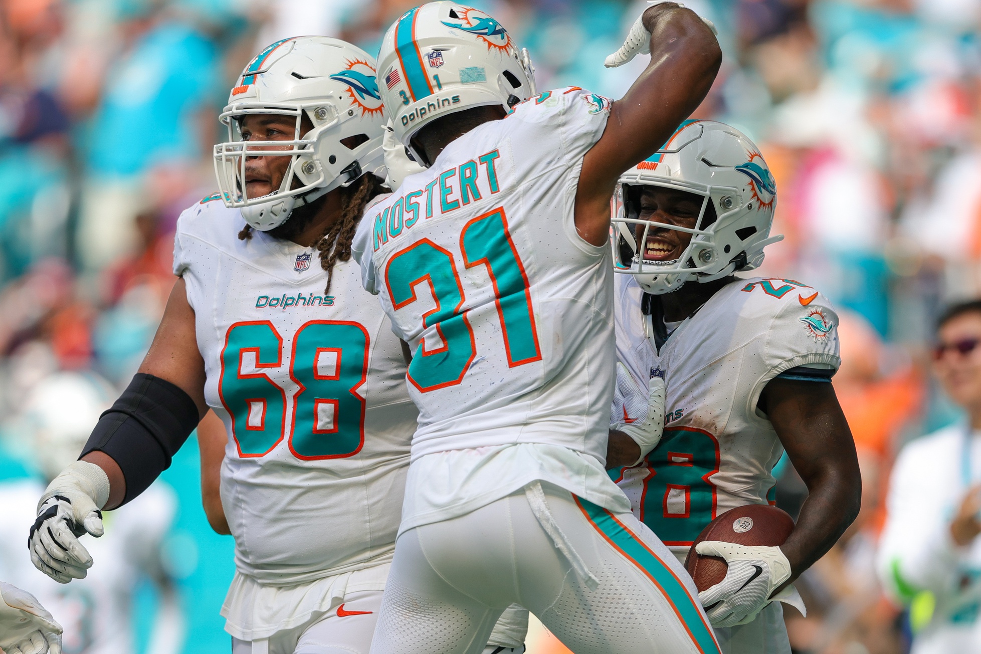 Sep 24, 2023; Miami Gardens, Florida, USA; Miami Dolphins running back De'Von Achane (28) celebrates his touchdown with Miami Dolphins running back Raheem Mostert (31) against the Denver Broncos in the fourth quarter at Hard Rock Stadium. Mandatory Credit: Nathan Ray Seebeck-USA TODAY Sports