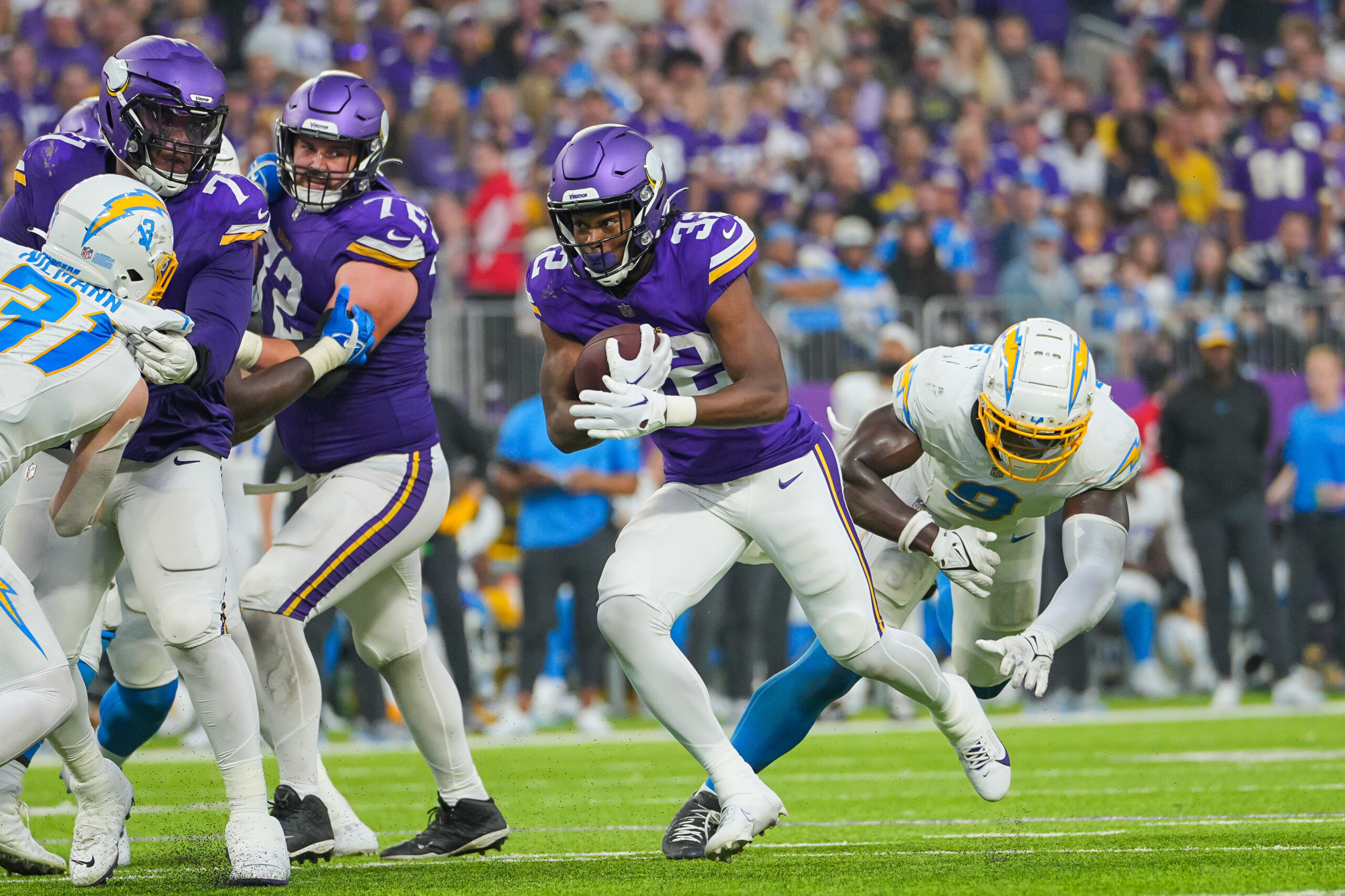 Sep 24, 2023; Minneapolis, Minnesota, USA; NFL Minnesota Vikings running back Ty Chandler (32) runs with the ball against the Los Angeles Chargers in the Los Angeles Chargers quarter at U.S. Bank Stadium. Mandatory Credit: Brad Rempel-USA TODAY Sports