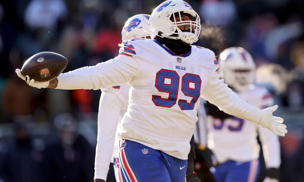 CHICAGO, ILLINOIS - DECEMBER 24: Tim Settle #99 of the Buffalo Bills celebrates a recovered fumble during the third quarter in the game against the Chicago Bears at Soldier Field on December 24, 2022 in Chicago, Illinois. (Photo by Michael Reaves/Getty Images)