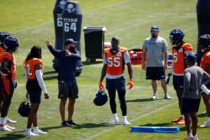 Jul 28, 2023; Englewood, CO, USA; Denver Broncos outside linebackers coach Michael Wilhoite talks with linebacker Nik Bonitto (42) and linebacker Frank Clark (55) and linebacker Randy Gregory (5) during training camp at Centura Health Training Center. Mandatory Credit: Isaiah J. Downing-USA TODAY Sports