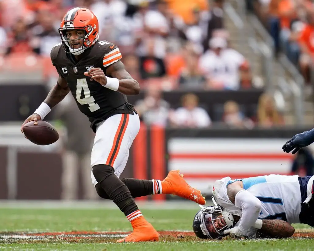 Cleveland Browns quarterback Deshaun Watson (4) escapes from Tennessee Titans safety Amani Hooker (37) during the second quarter in Cleveland, Ohio, Sunday, Sept. 24, 2023. © Andrew Nelles / The Tennessean / USA TODAY NETWORK