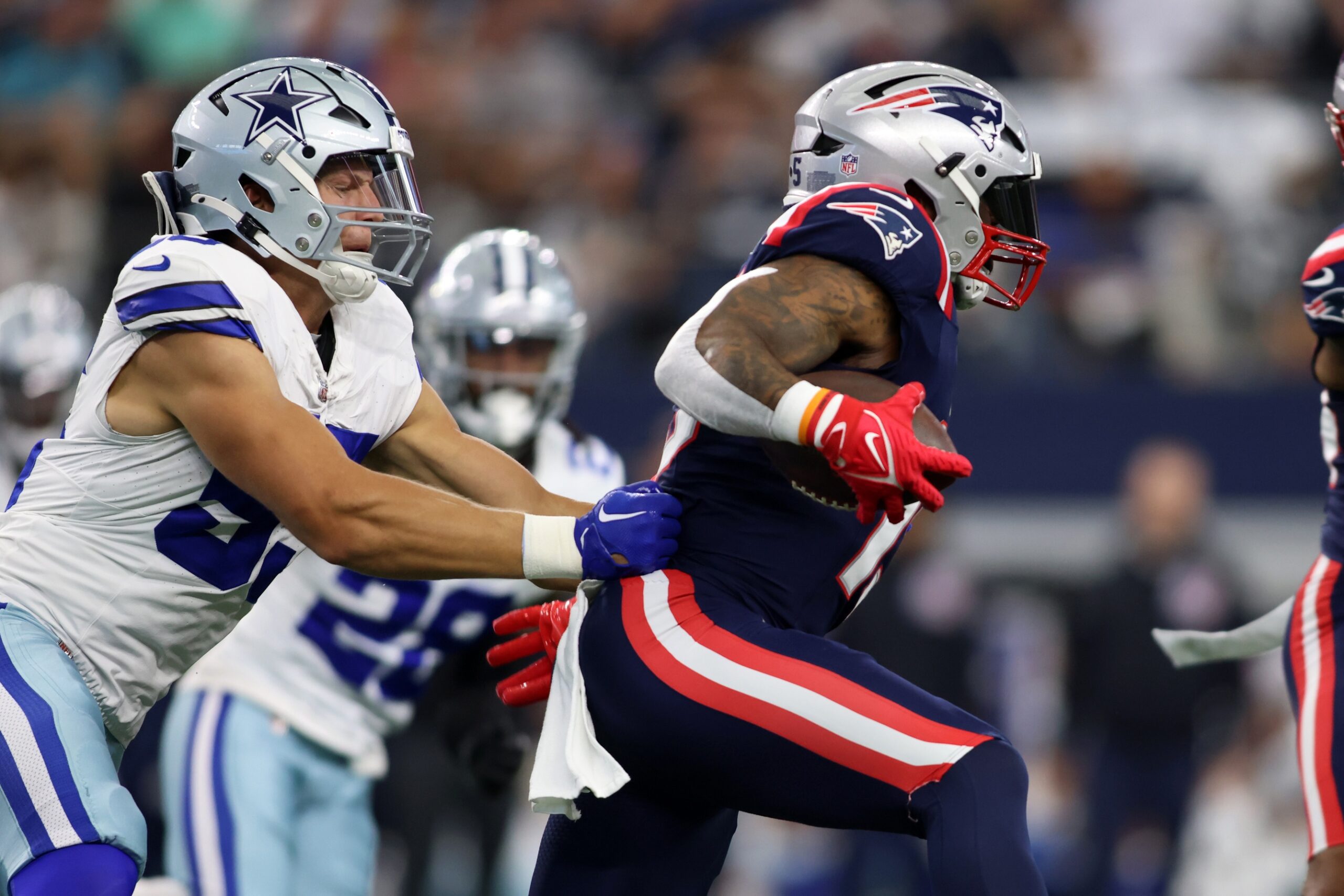 Oct 1, 2023; Arlington, Texas, USA; New England Patriots running back Ezekiel Elliott (15) runs the ball against Dallas Cowboys linebacker Leighton Vander Esch (55) in the first quarter at AT&T Stadium. Mandatory Credit: Tim Heitman-USA TODAY Sports