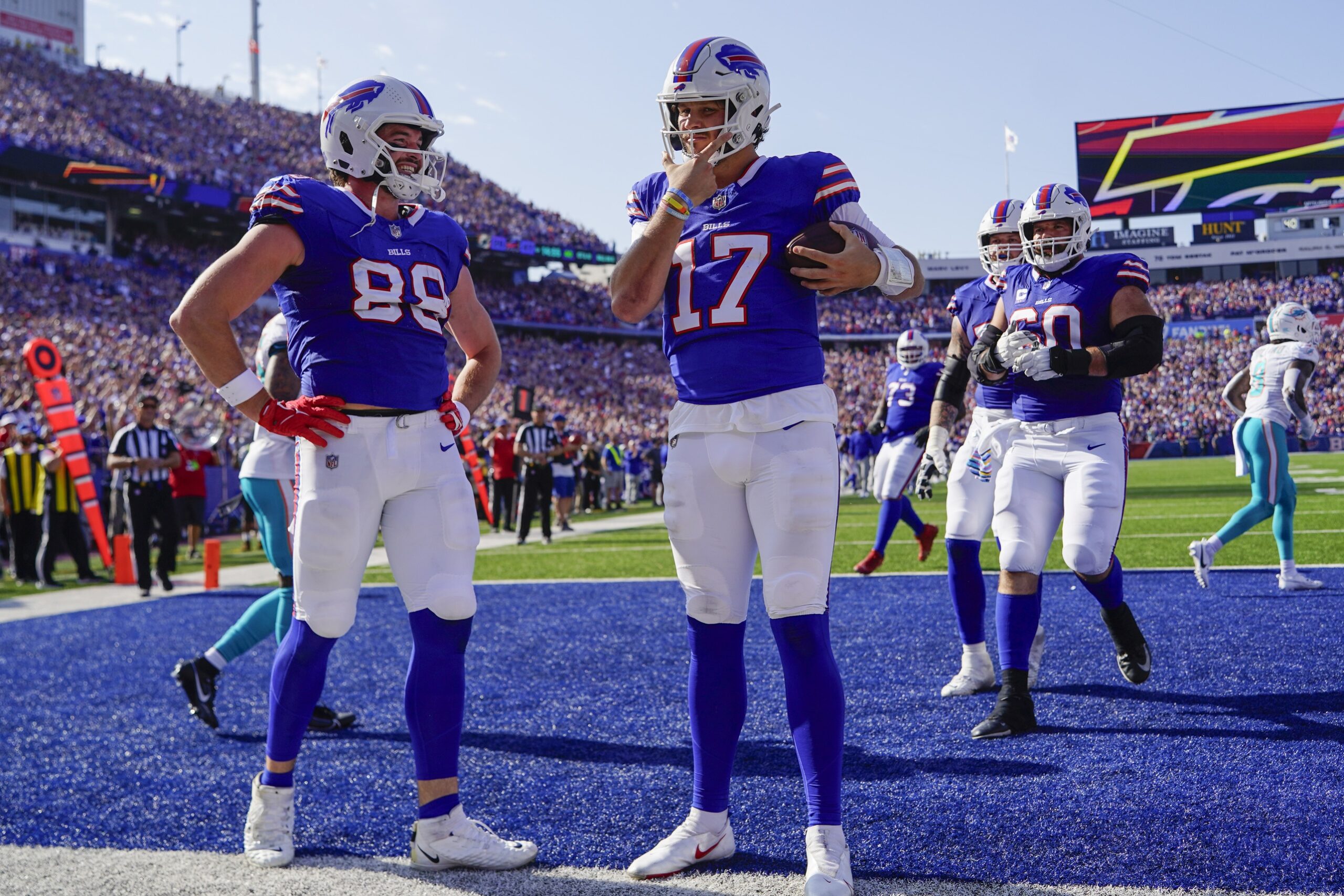 Oct 1, 2023; Orchard Park, New York, USA; injury Buffalo Bills hamlin quarterback Josh Allen (17) reacts to scoring a touchdown with Buffalo Bills tight end Dawson Knox (88) during the second half against the Miami Dolphins at Highmark Stadium. Mandatory Credit: Gregory Fisher-USA TODAY Sports
