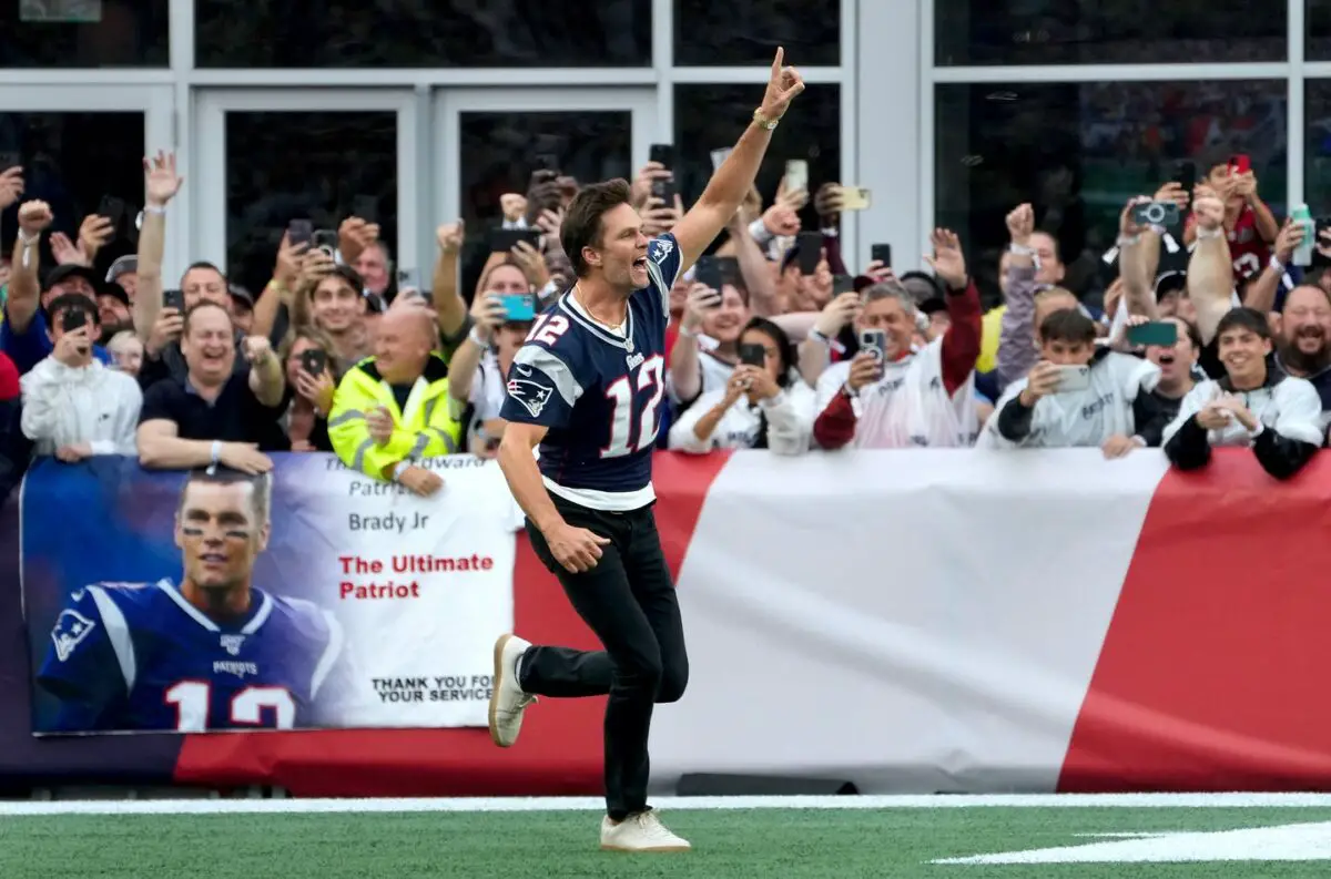 Former New England Patriots quarterback, Tom Brady, runs on to the field at Gillette Stadium on Sunday evening to welcome fans as the Patriots announce they will induct him into the Patriots Hall of Fame in June. © Kris Craig / USA TODAY NETWORK