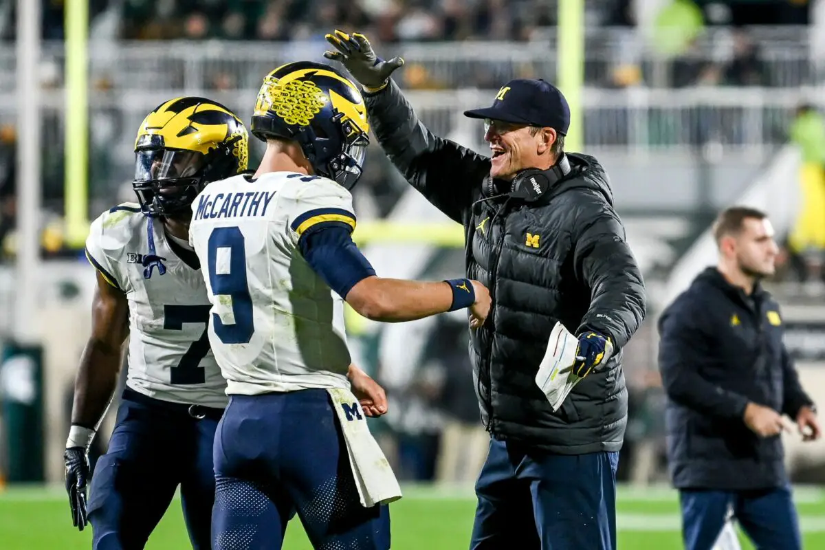 Michigan head coach Jim Harbaugh, right, celebrates with quarterback J.J. McCarthy after McCarthy’s touchdown pass against Michigan State during the third quarter on Saturday, Oct. 21, 2023, at Spartan Stadium in East Lansing. © Nick King/Lansing State Journal / USA TODAY NETWORK (Las Vegas Raiders)
