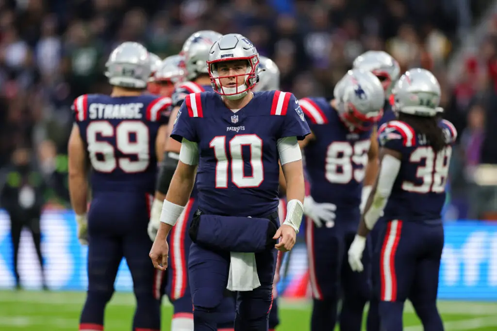 Nov 12, 2023; Frankfurt, Germany; New England Patriots quarterback Mac Jones (10) looks on during a time out against the Indianapolis Colts in the second quarter during an International Series game at Deutsche Bank Park. Mandatory Credit: Nathan Ray Seebeck-USA TODAY Sports (Tom Brady)