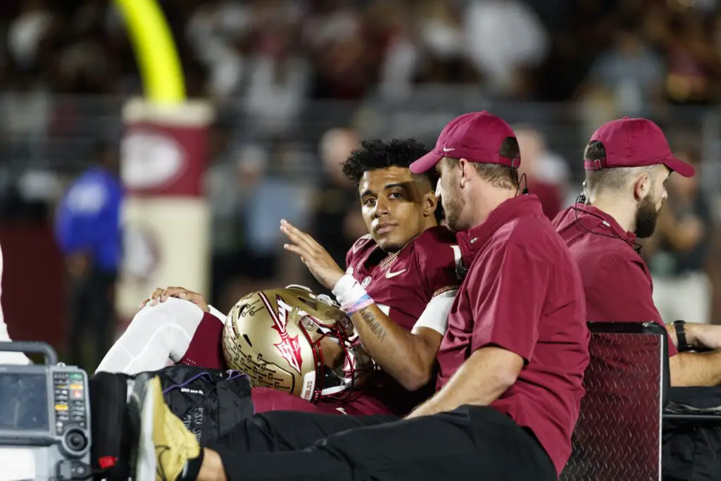 Nov 18, 2023; Tallahassee, Florida, USA; Florida State Seminoles quarterback Jordan Travis (13) waves to fans while being carted off after an injury against the North Alabama Lions during the first quarter at Doak S. Campbell Stadium. Mandatory Credit: Morgan Tencza-USA TODAY Sports (Alabama)