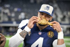 Nov 23, 2023; Arlington, Texas, USA; Dallas Cowboys Dak Prescott (4) eats a turkey leg after the Cowboys victory over the Washington Commanders at AT&T Stadium. Mandatory Credit: Jerome Miron-USA TODAY Sports
