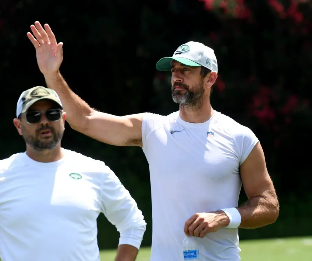 The Carolina Panthers and the New York Jets held a joint training camp practice at Wofford in Spartanburg on Aug. 9, 2023. New York Jets quarterback Aaron Rodgers (8), center, waves to fans after practice.