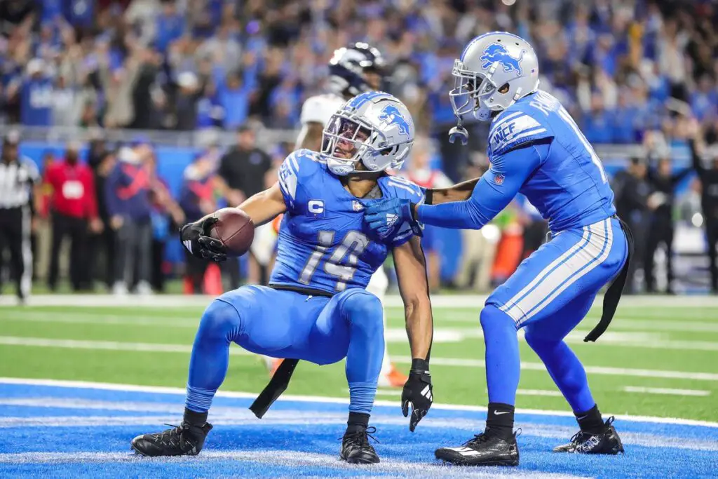 Detroit Lions wide receiver Amon-Ra St. Brown celebrates a touchdown against Denver Broncos with wide receiver Kalif Raymond during the first half at Ford Field in Detroit on Saturday, Dec. 16, 2023.